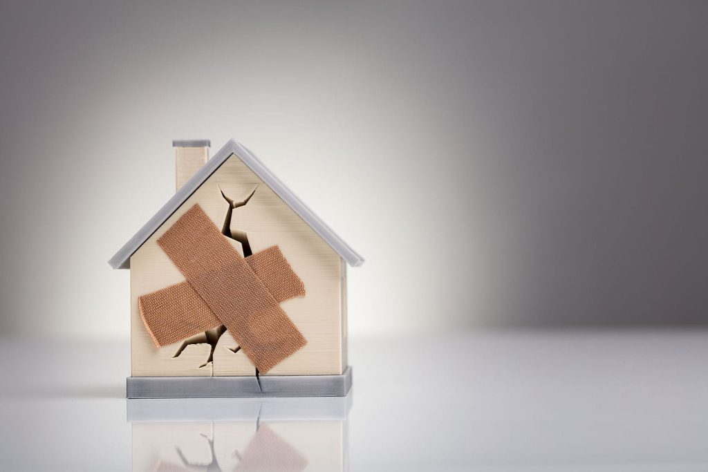 Distressed house in Central Connecticut with visible exterior damage, representing options for selling the property as-is